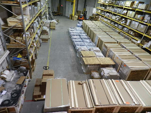 Elevated view of warehouse with rows of boxed parts and racking